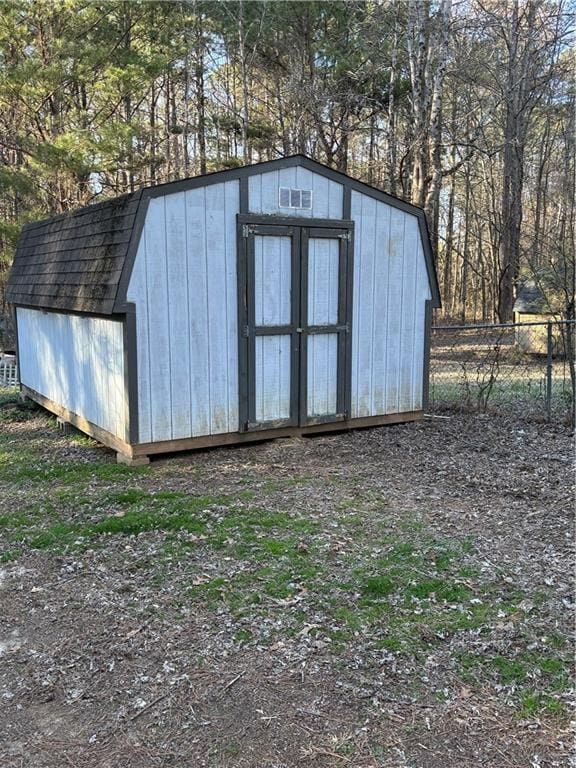 view of shed with fence