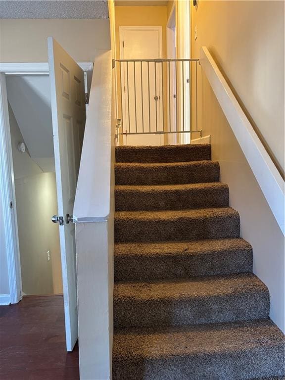 staircase featuring wood finished floors