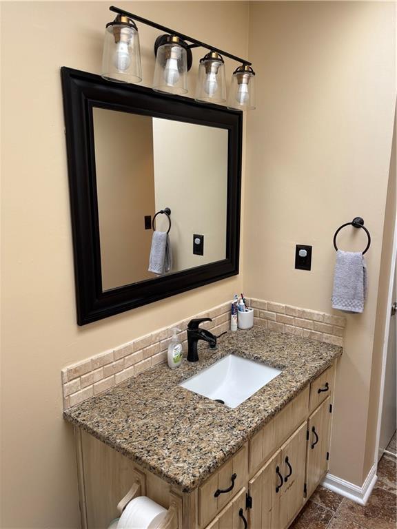 bathroom with vanity and baseboards