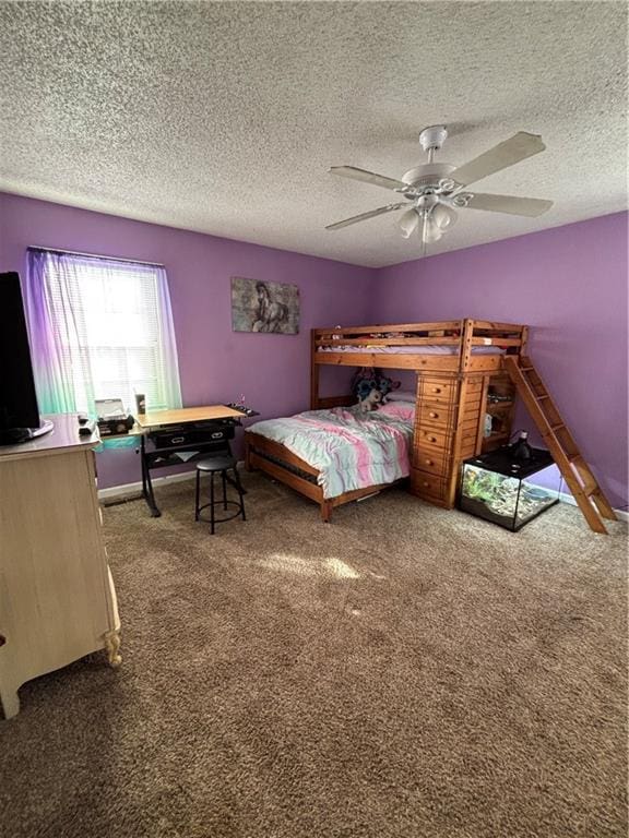 carpeted bedroom with a ceiling fan and a textured ceiling