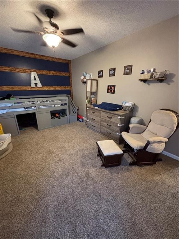 living room with a ceiling fan, carpet floors, and a textured ceiling