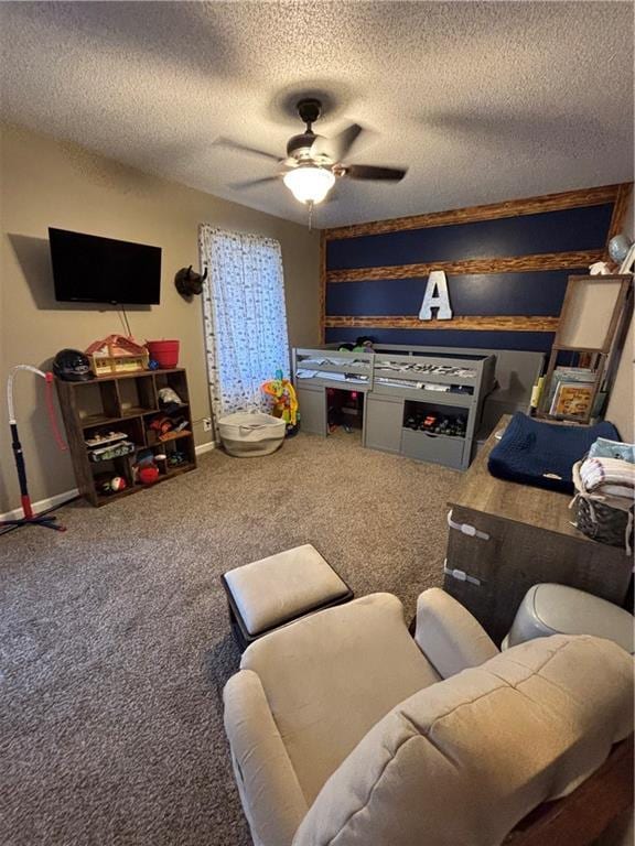 living area featuring carpet floors, a textured ceiling, and a ceiling fan