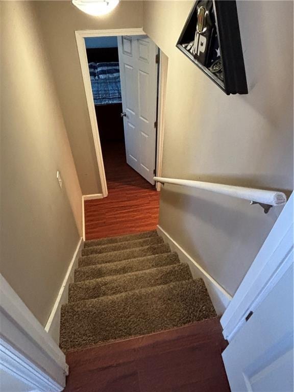 stairs featuring baseboards and wood finished floors