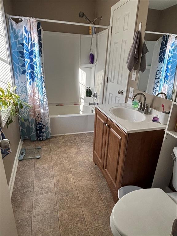 full bathroom featuring toilet, shower / tub combo, and plenty of natural light