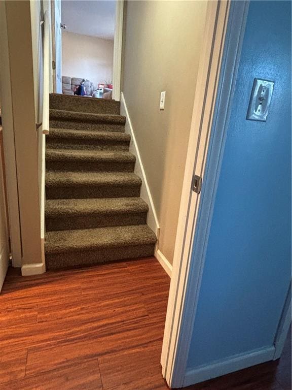 stairs featuring baseboards and wood finished floors