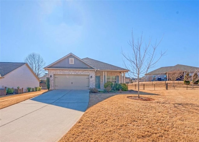 view of front of house featuring driveway, brick siding, an attached garage, and a front yard