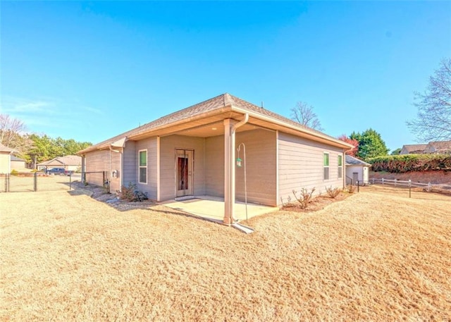 view of side of home with a patio area and fence