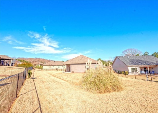 view of yard featuring a fenced backyard and a residential view