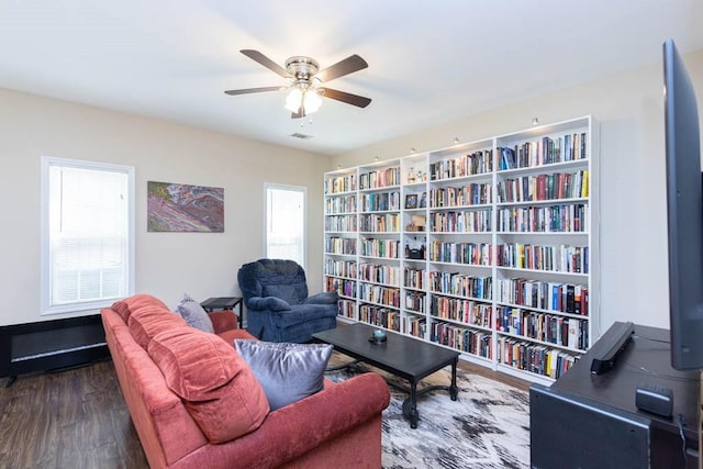 sitting room featuring dark wood-type flooring and ceiling fan