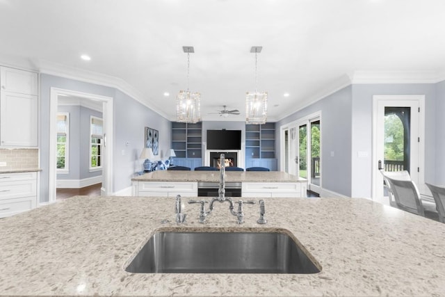 10150 Cedar Ridge Dr, Milton, GA 30004 - kitchen with open floor plan, a ceiling fan, white cabinetry, light stone counters, and decorative light fixtures