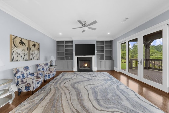 10150 Cedar Ridge Dr, Milton, GA 30004 - living area with wood finished floors, french doors, a lit fireplace, crown molding, and built in features