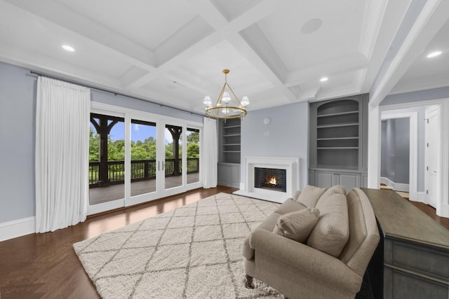 10150 Cedar Ridge Dr, Milton, GA 30004 - living room featuring built in shelves, a chandelier, recessed lighting, wood finished floors, and a lit fireplace