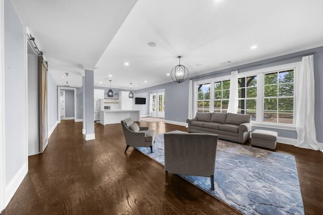10150 Cedar Ridge Dr, Milton, GA 30004 - living room featuring ornate columns, dark wood-type flooring, recessed lighting, and healthy amount of natural light
