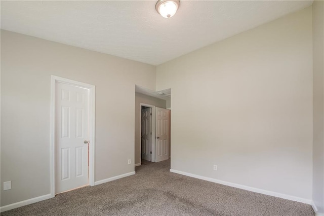 unfurnished bedroom featuring baseboards and carpet flooring