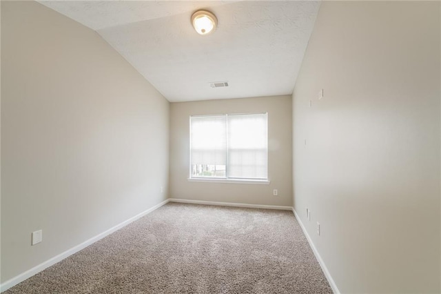 empty room with light carpet, visible vents, and baseboards