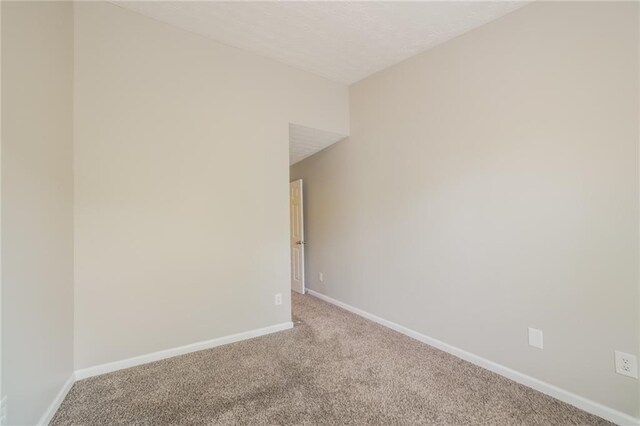 empty room with carpet floors and baseboards