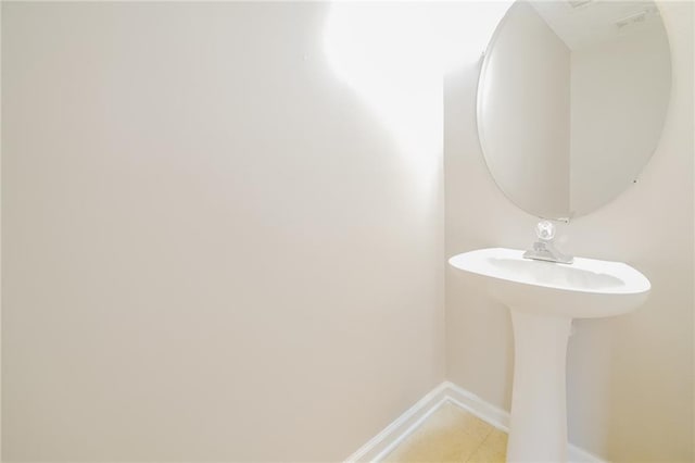 bathroom with tile patterned floors and baseboards