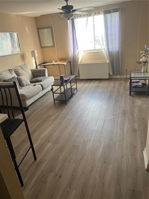 living room featuring hardwood / wood-style flooring and ceiling fan