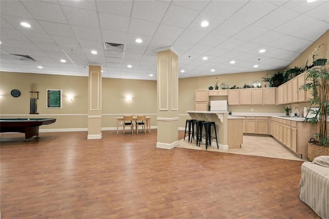 1501 Clairmont Rd Unit 1027, Decatur, GA 30033 - kitchen with decorative columns, light countertops, light brown cabinetry, a sink, and fridge