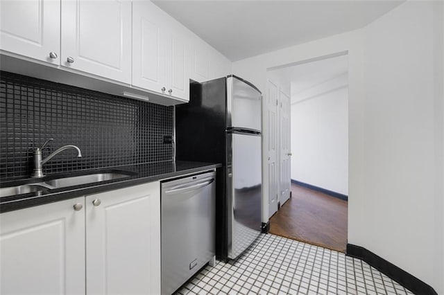 1501 Clairmont Rd Unit 1027, Decatur, GA 30033 - kitchen with tasteful backsplash, dark countertops, appliances with stainless steel finishes, white cabinets, and a sink