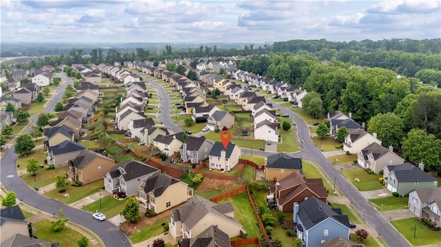 aerial view of property and surrounding area featuring nearby suburban area