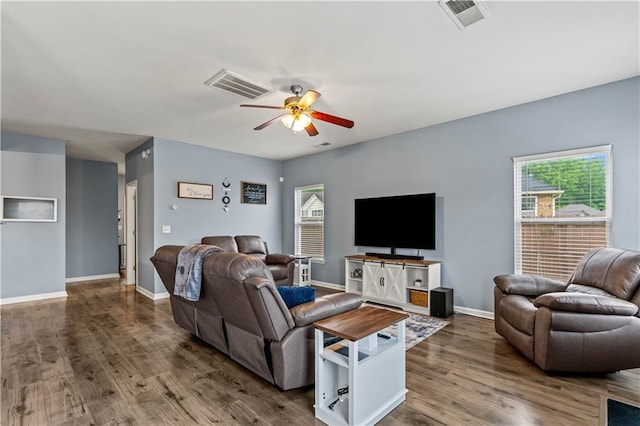 living room featuring a ceiling fan, wood finished floors, and baseboards