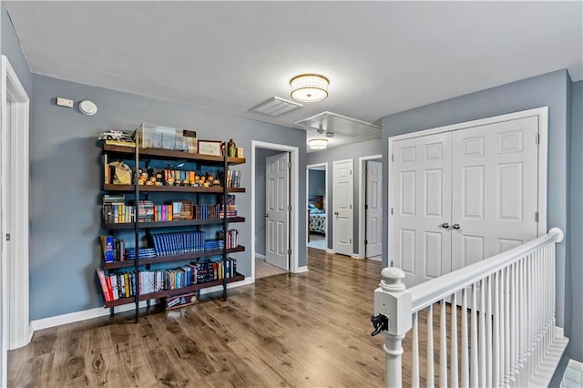 game room with attic access, baseboards, and wood finished floors