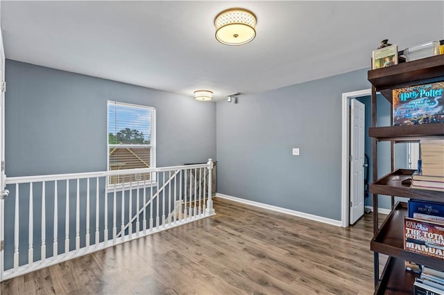 unfurnished room featuring wood finished floors and baseboards