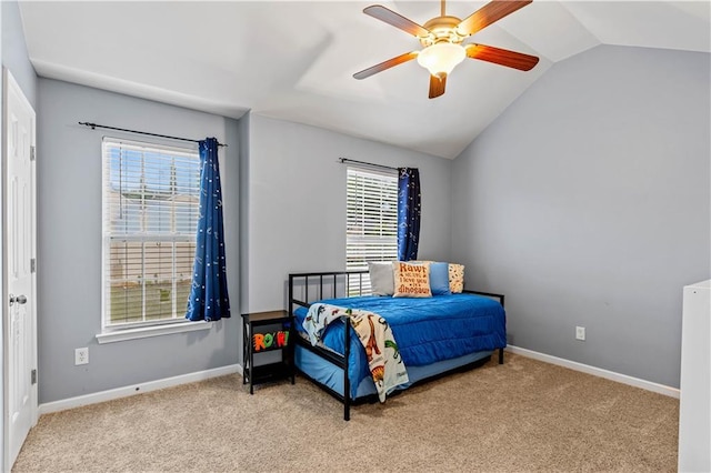 bedroom featuring carpet, vaulted ceiling, baseboards, and a ceiling fan