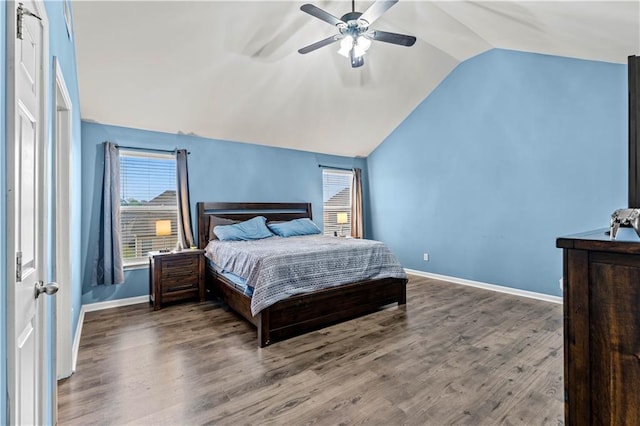 bedroom with vaulted ceiling, wood finished floors, baseboards, and a ceiling fan
