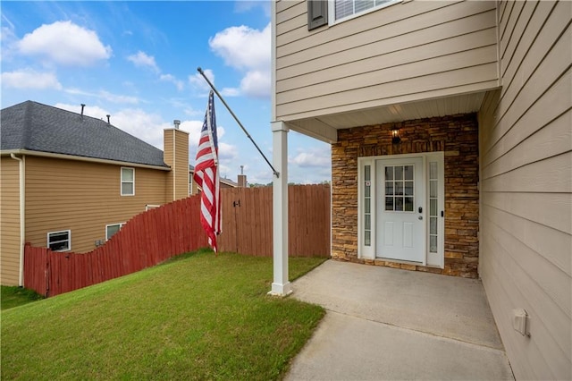entrance to property with stone siding and a patio area