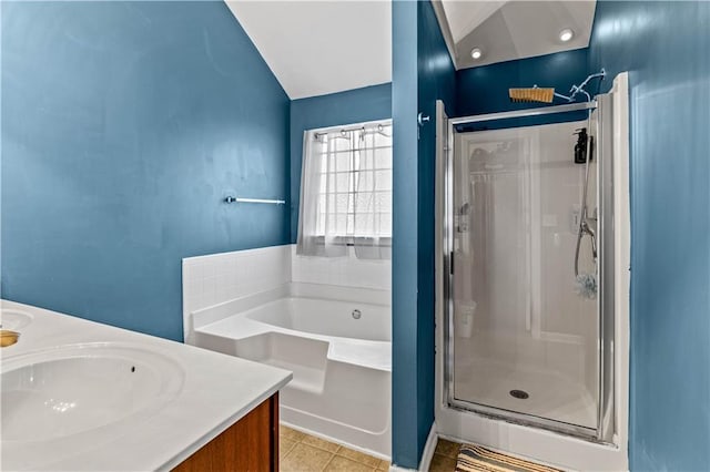 full bath featuring a shower stall, a bath, tile patterned flooring, vaulted ceiling, and double vanity