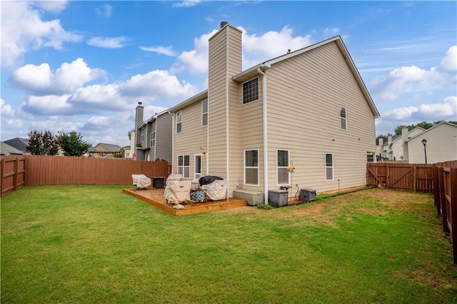 rear view of house featuring a chimney, a deck, and central AC