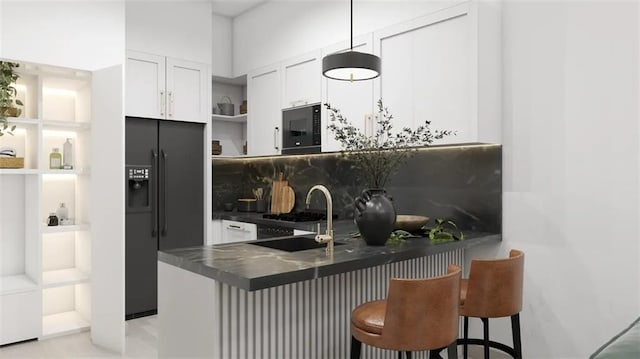 kitchen featuring sink, white cabinetry, a kitchen breakfast bar, black appliances, and kitchen peninsula