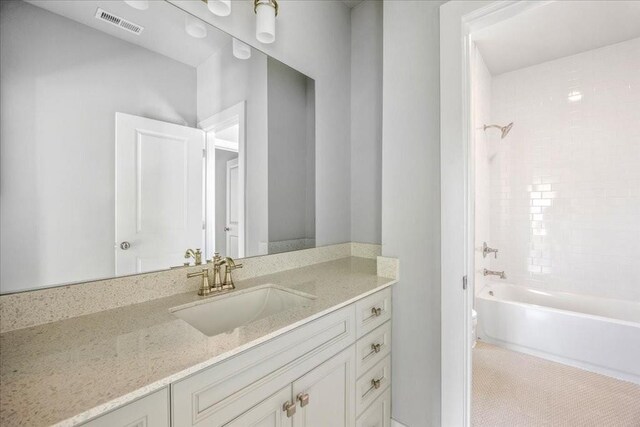 bathroom featuring tile patterned floors, tiled shower / bath combo, and toilet