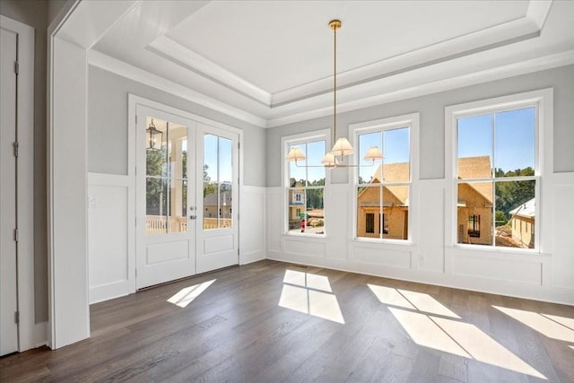 doorway featuring dark hardwood / wood-style floors, a raised ceiling, and french doors