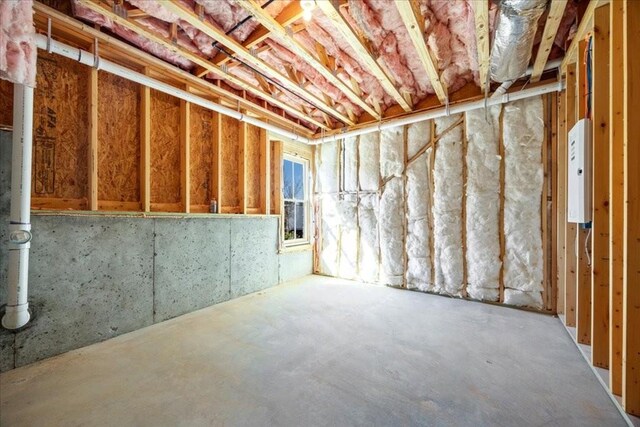 unfurnished living room with beamed ceiling, dark wood-type flooring, coffered ceiling, and a notable chandelier