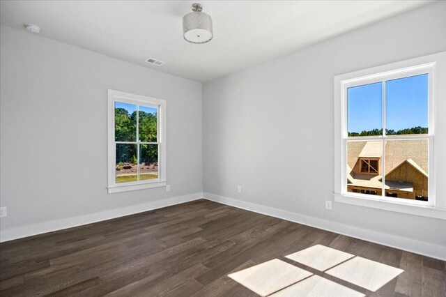 unfurnished room featuring dark hardwood / wood-style flooring