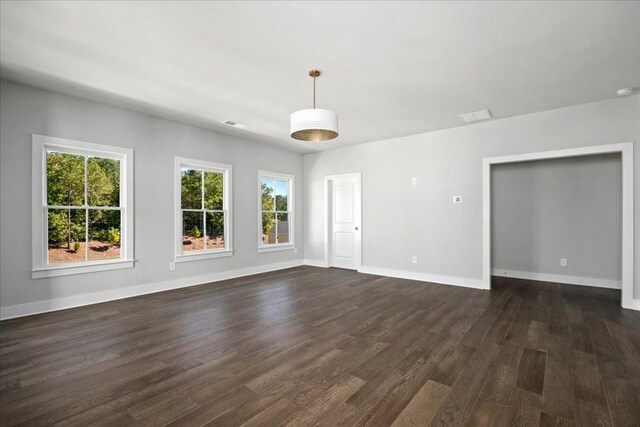 unfurnished living room featuring beam ceiling, sink, and dark hardwood / wood-style floors