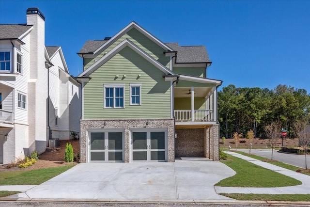 view of front of property featuring central AC unit and a garage