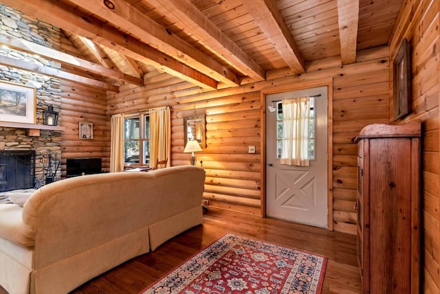 living room with wood ceiling, wood-type flooring, a fireplace, and log walls