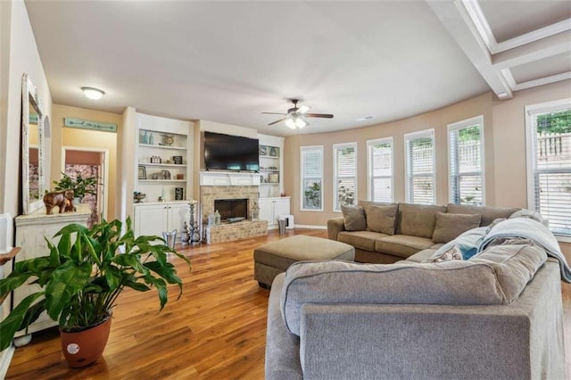 1249 Austin Thomas Dr, Dacula, GA 30019 - living area featuring a ceiling fan, a brick fireplace, wood finished floors, and ornamental molding