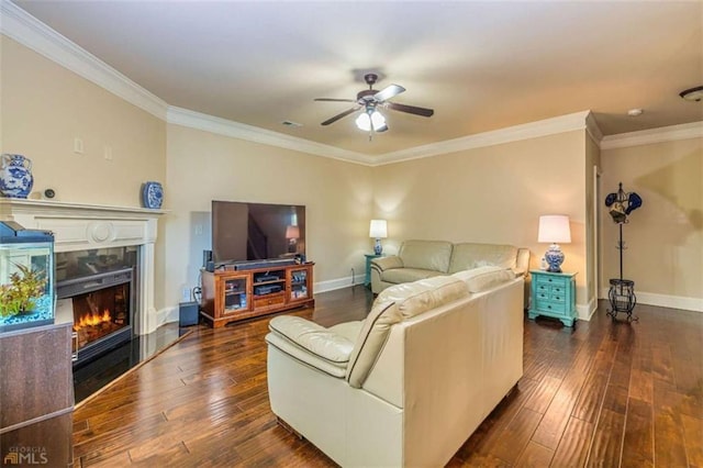 43 Greencove Ct, Newnan, GA 30265 - living room with ornamental molding, ceiling fan, dark wood finished floors, a fireplace, and baseboards
