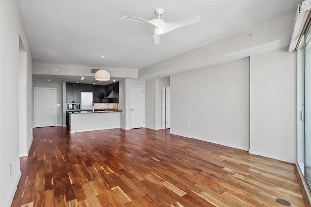 unfurnished living room with ceiling fan and hardwood / wood-style flooring