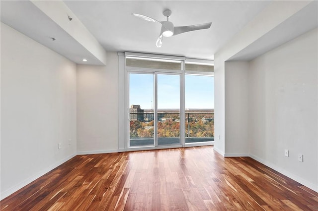 spare room with ceiling fan and dark wood-type flooring