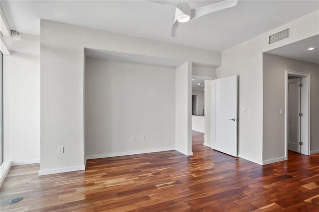 spare room featuring dark hardwood / wood-style flooring and ceiling fan