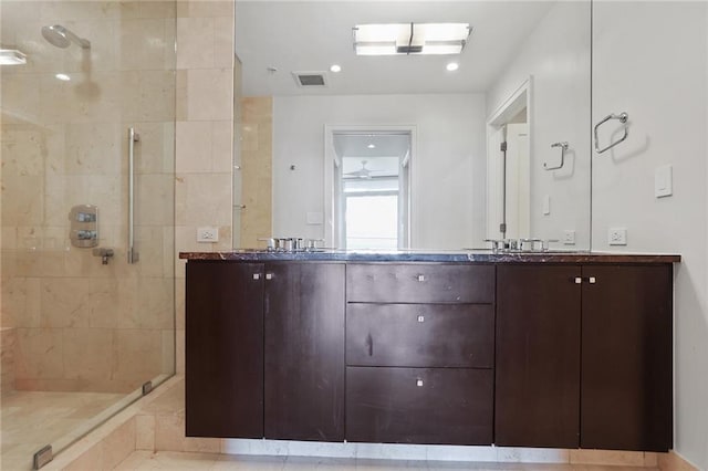 bathroom featuring tiled shower, vanity, and tile patterned floors