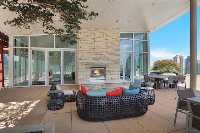 view of patio featuring an outdoor living space with a fireplace