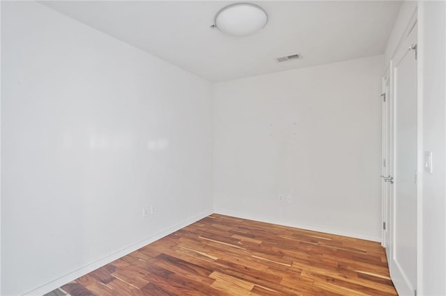 unfurnished room with wood-type flooring