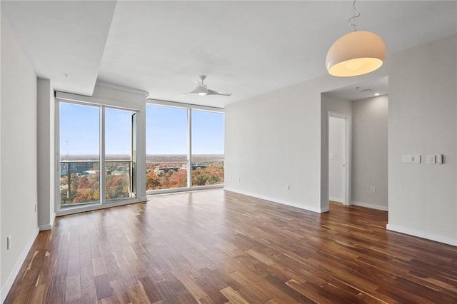 spare room featuring ceiling fan and dark wood-type flooring